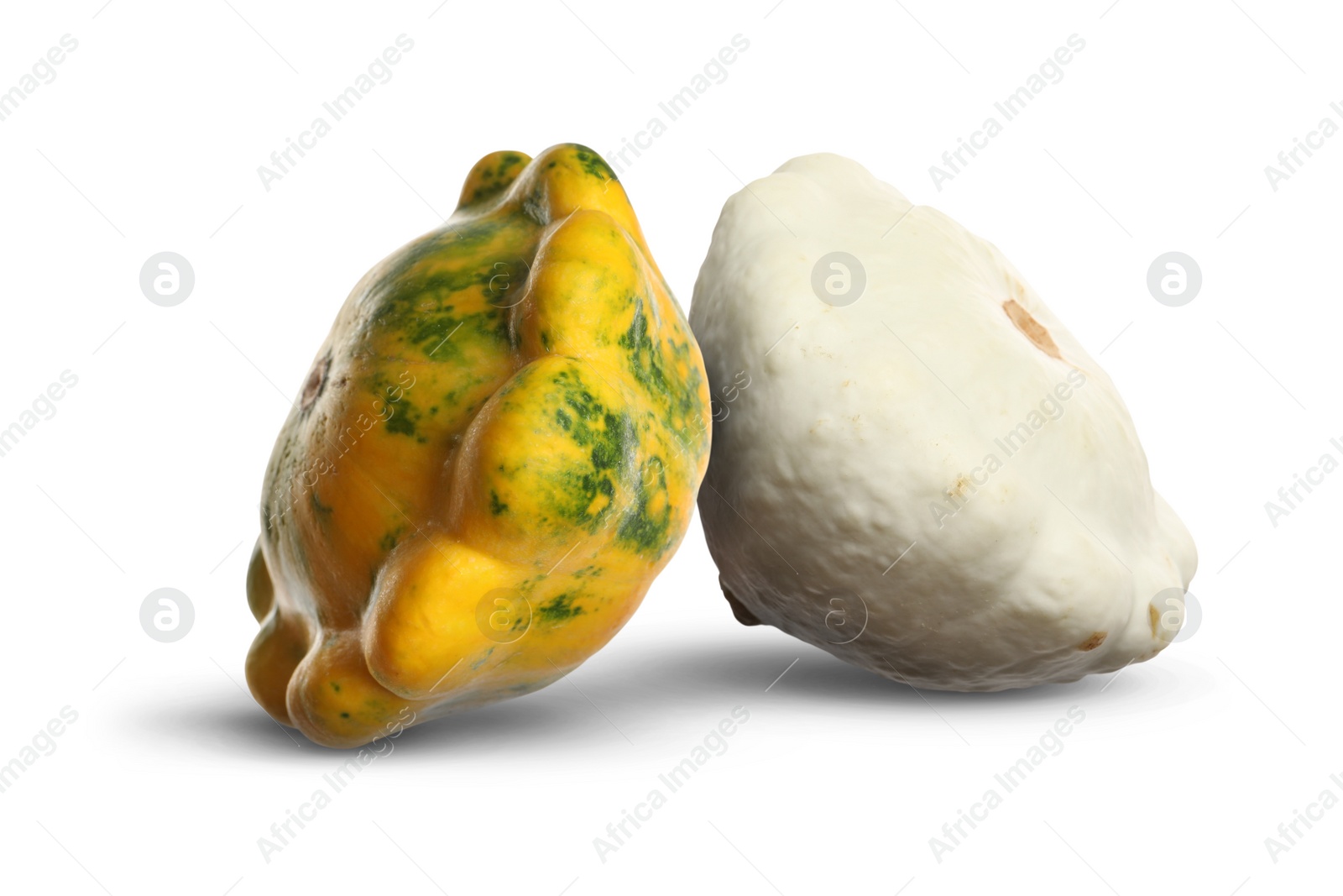 Image of Two fresh different pattypan squashes on white background