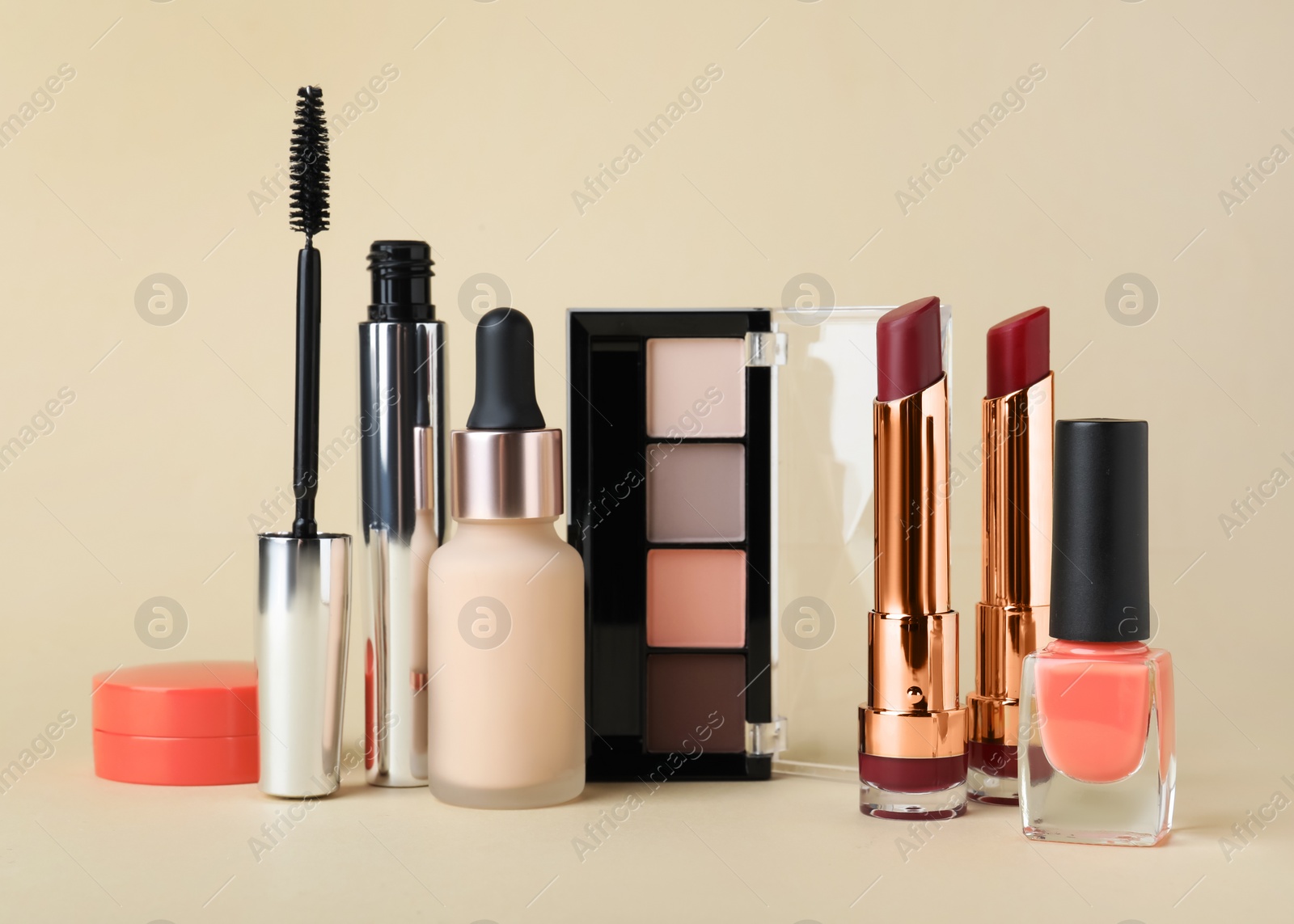 Photo of Different luxury decorative cosmetics on beige background