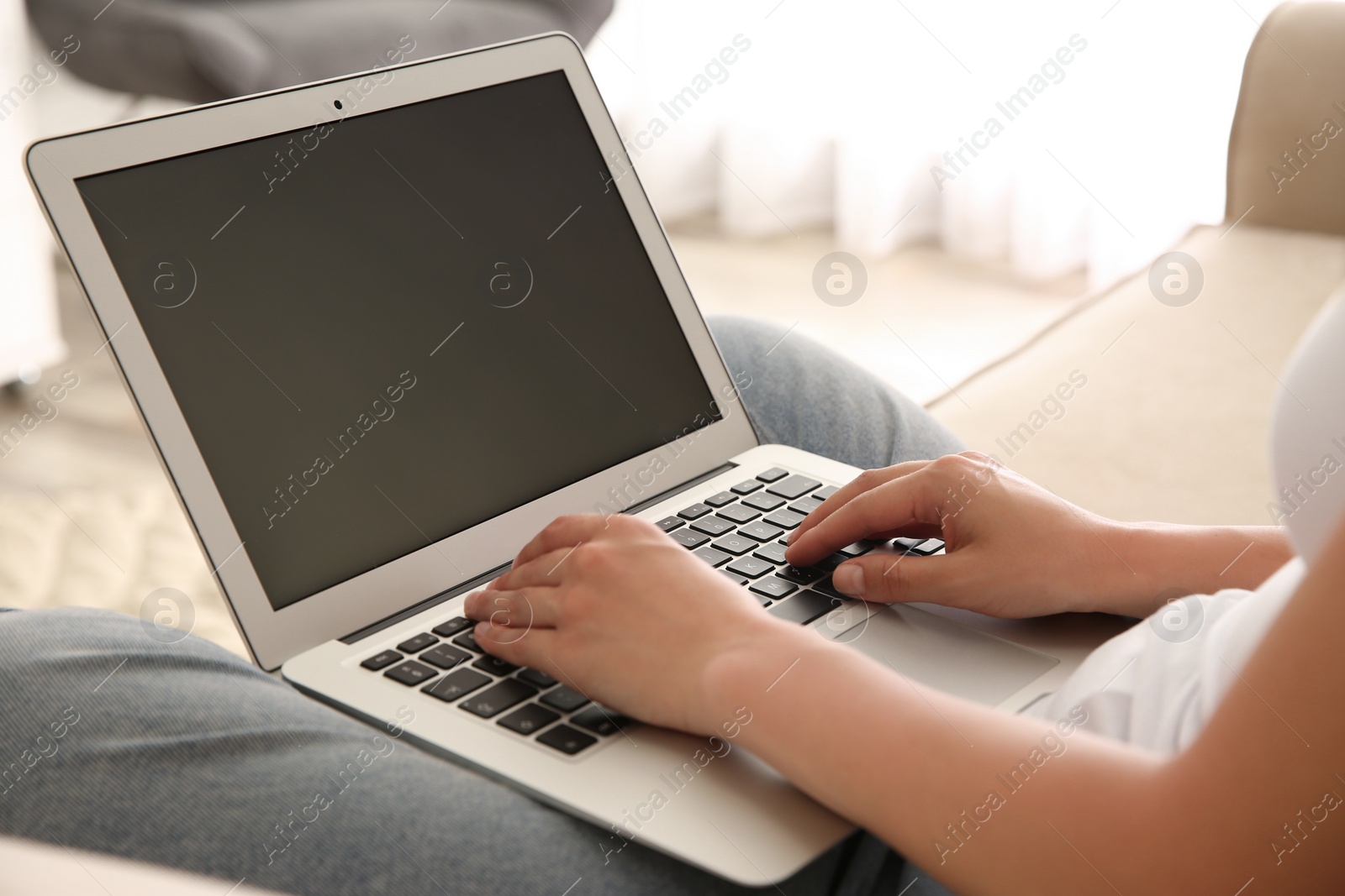 Photo of Woman working with modern laptop indoors, closeup. Space for design