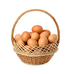 Chicken eggs in wicker basket isolated on white