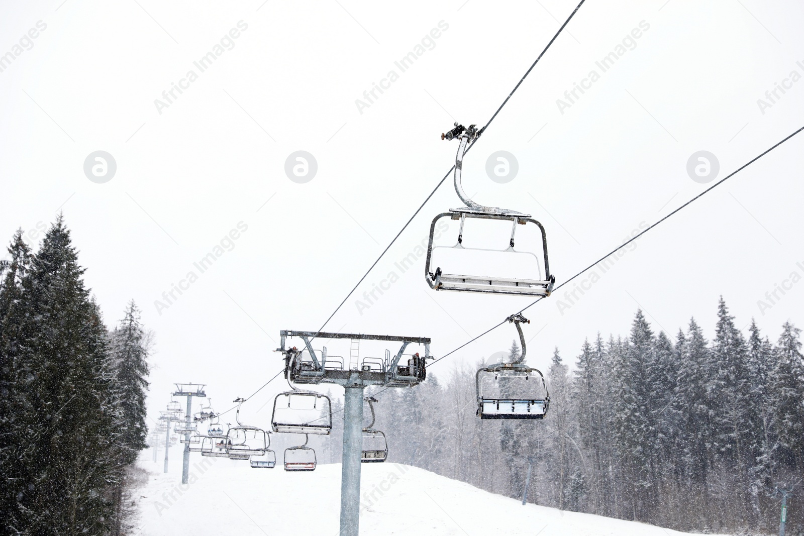 Photo of Ski lift at snowy mountain resort. Winter vacation