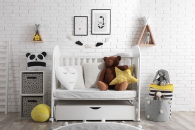 Photo of Cozy room with stylish furniture and toys for baby. Interior design