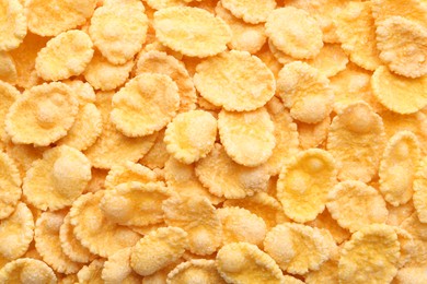 Photo of Sweet tasty corn flakes as background, top view