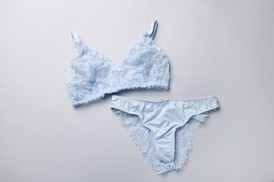 Photo of Light blue women's underwear on grey background, flat lay