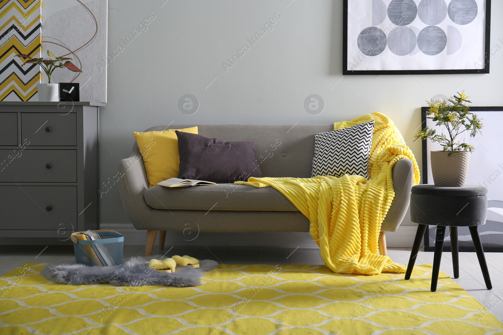 Photo of Comfortable sofa with pillows and plaid in living room. Interior design