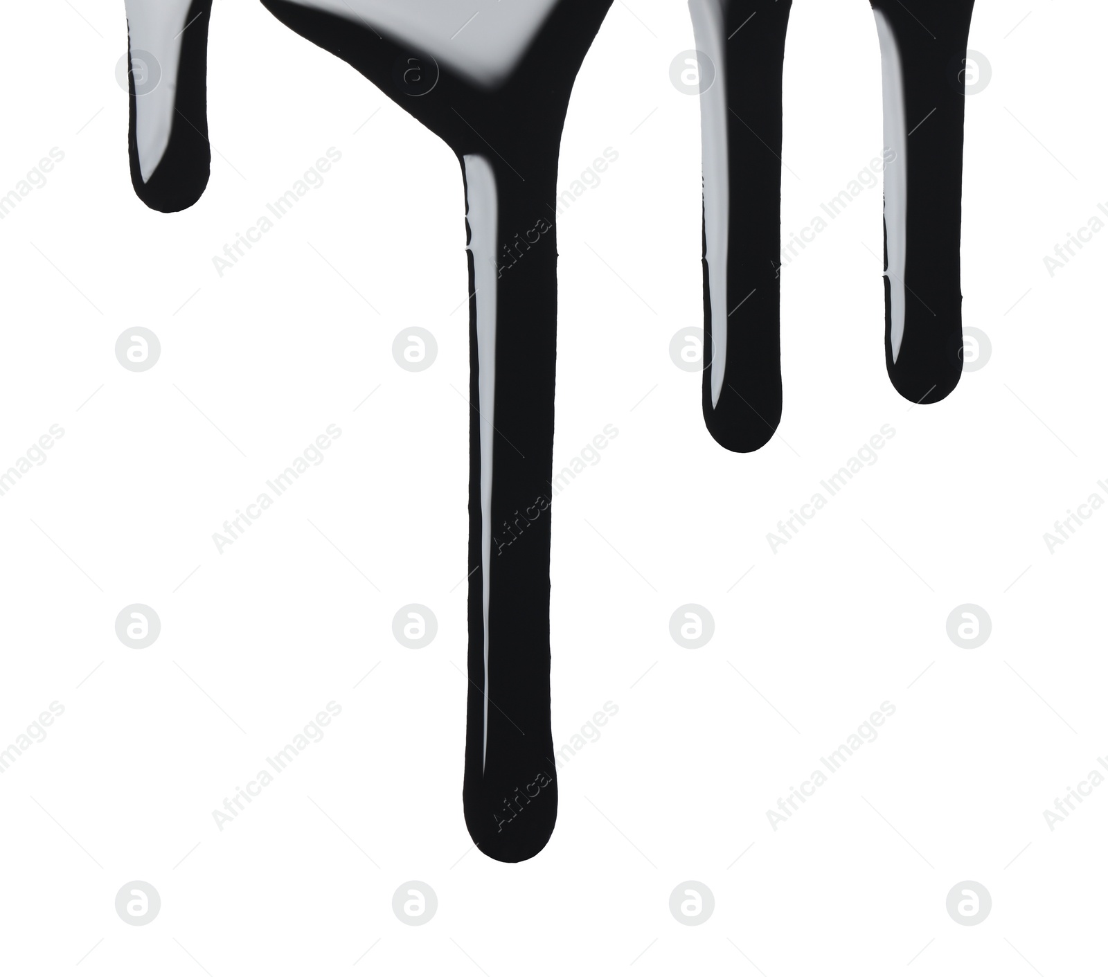 Photo of Black glossy oil flowing on white background