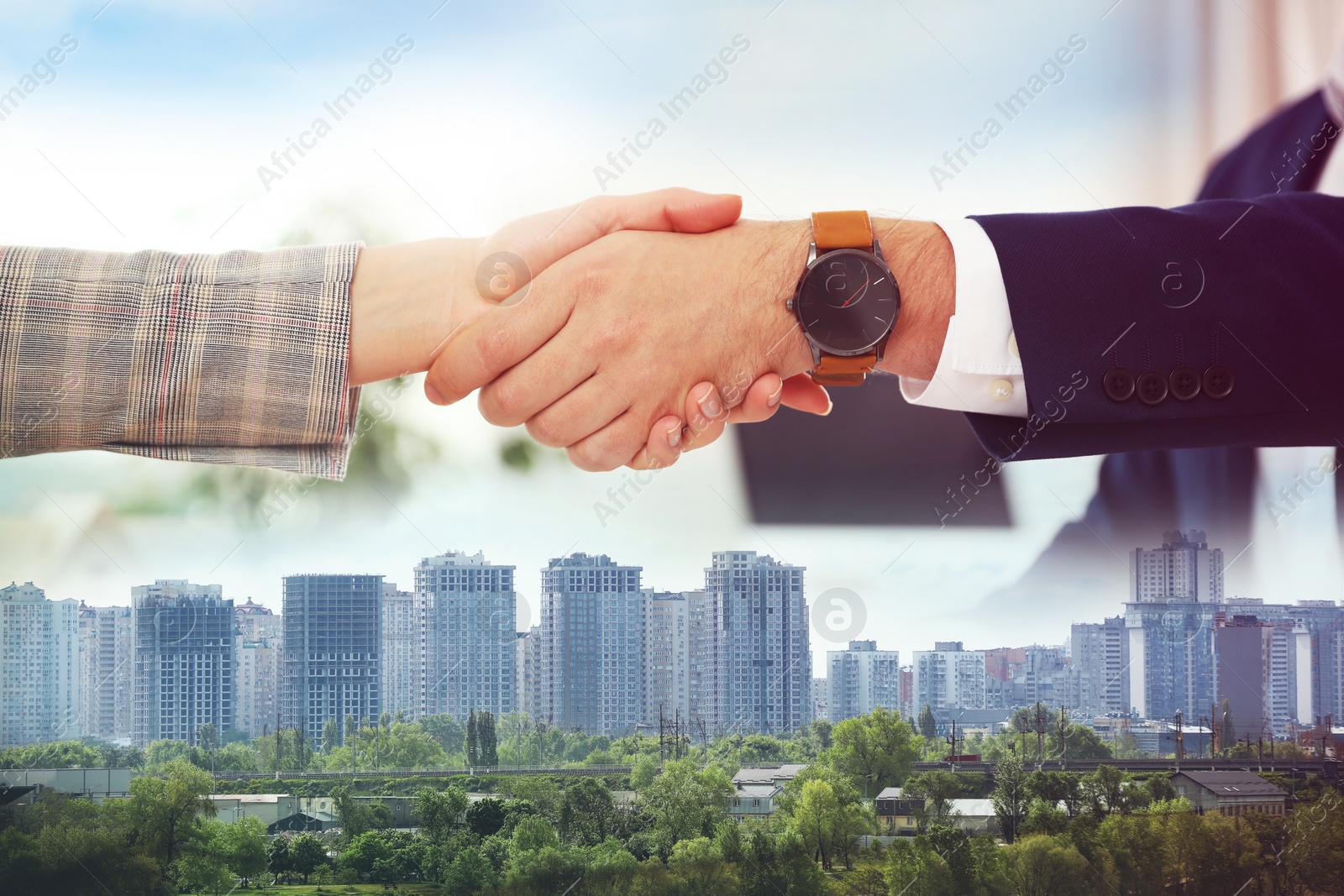 Image of Deal or partnership concept. Double exposure with cityscape and photo of businesspeople shaking hands