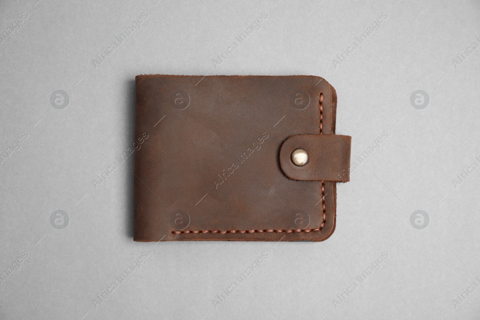 Photo of Stylish brown leather wallet on light grey background, top view