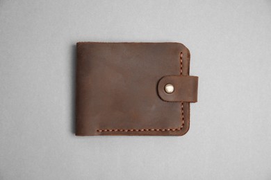 Stylish brown leather wallet on light grey background, top view