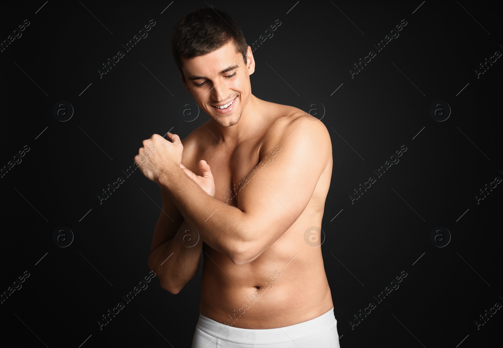 Photo of Man with sexy body on grey background. Space for text