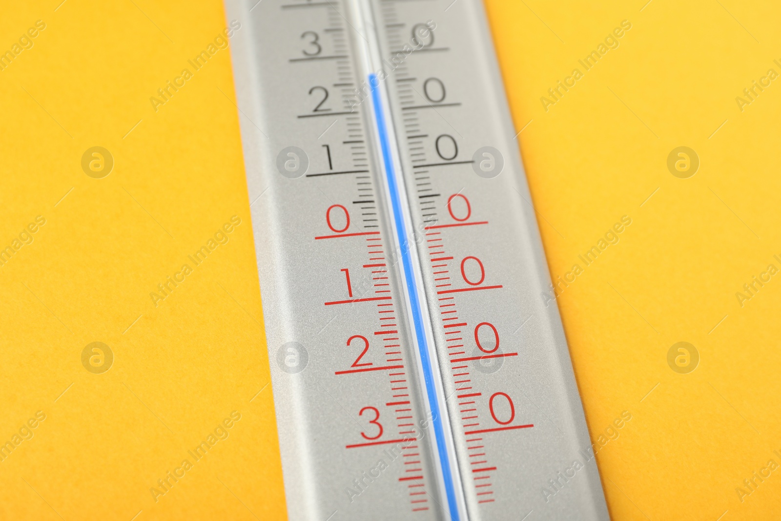 Photo of Modern weather thermometer on yellow background, closeup