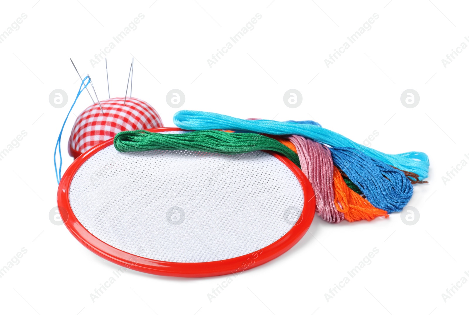 Photo of Colorful threads and different embroidery accessories on white background