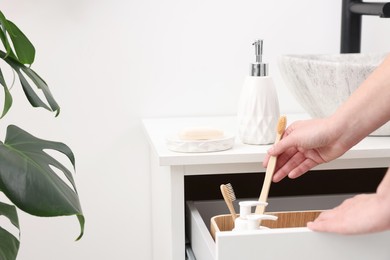 Photo of Bath accessories. Woman with toothbrush indoors, closeup and space for text
