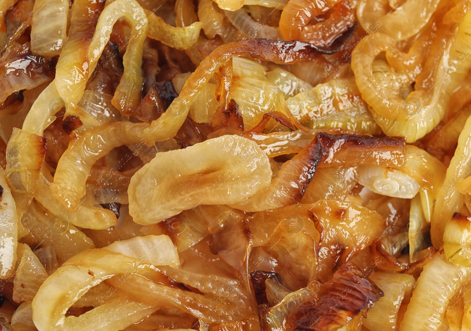 Photo of Tasty fried onion as background, top view