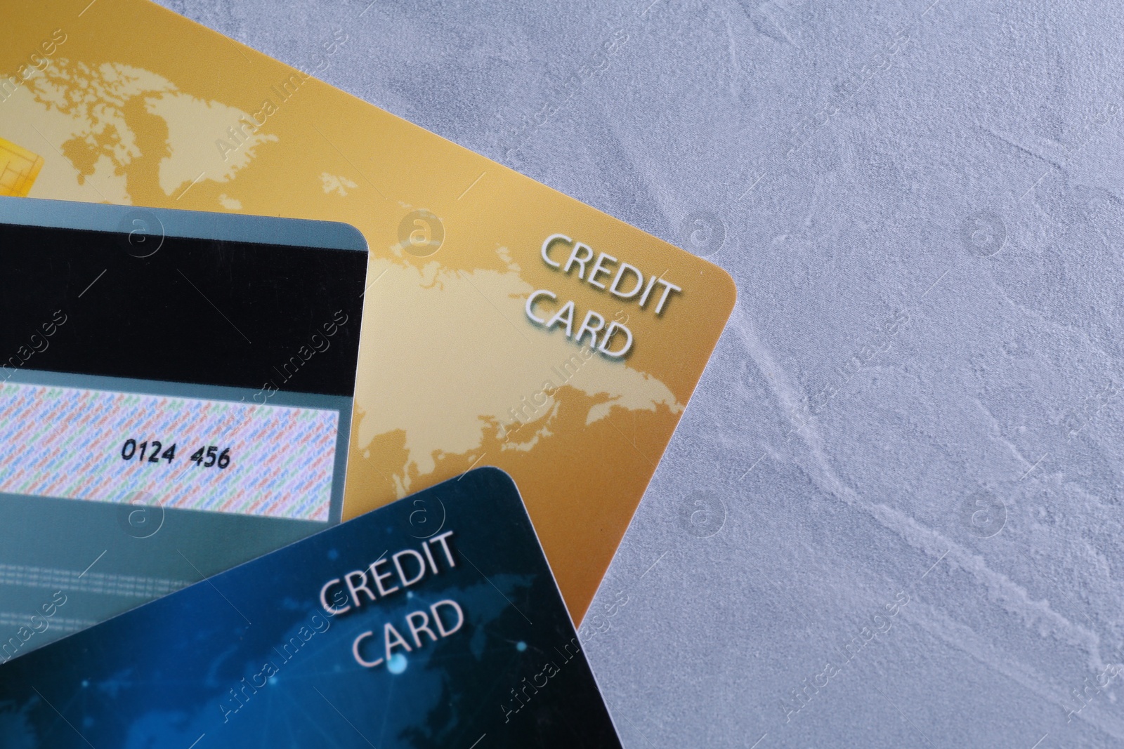 Photo of Credit cards on grey textured table, flat lay. Space for text