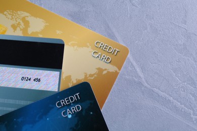 Photo of Credit cards on grey textured table, flat lay. Space for text