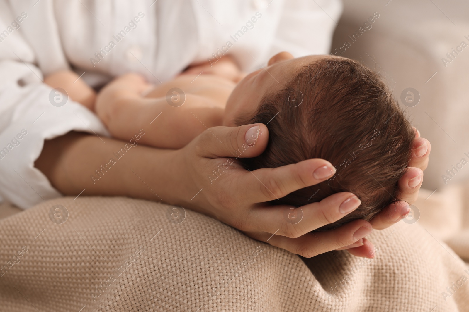 Photo of Mother holding her newborn baby, closeup view