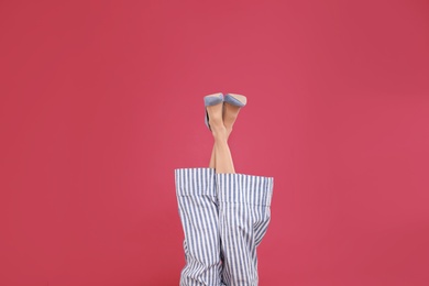 Photo of Woman in elegant shoes on crimson background