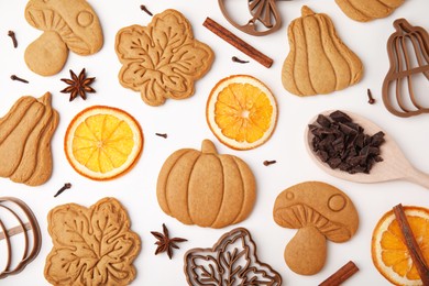 Flat lay composition with tasty cookies, cutters and spices on white table