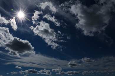 Photo of Picturesque blue sky with white clouds and bright sun