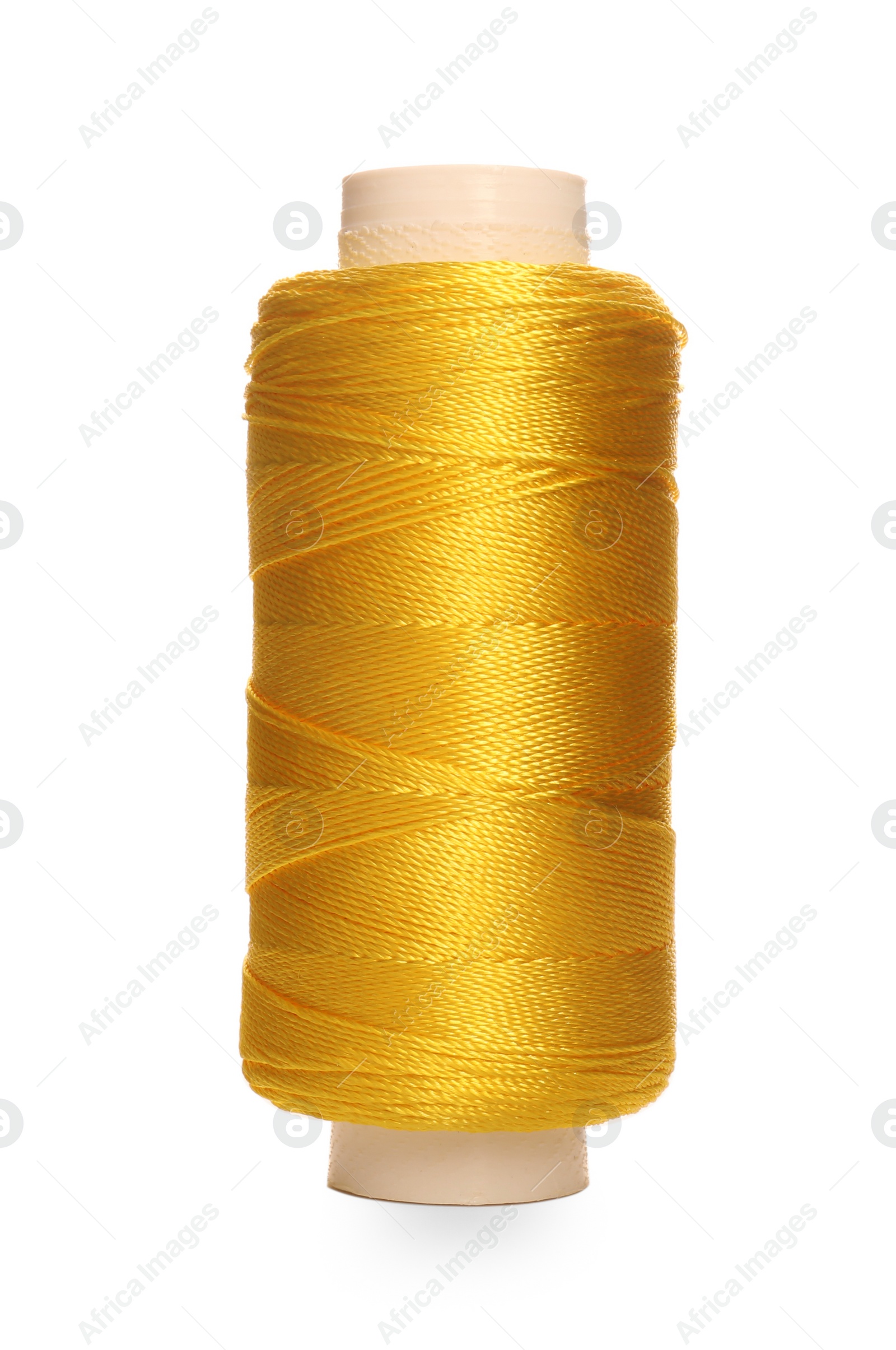 Photo of Spool of yellow sewing thread isolated on white