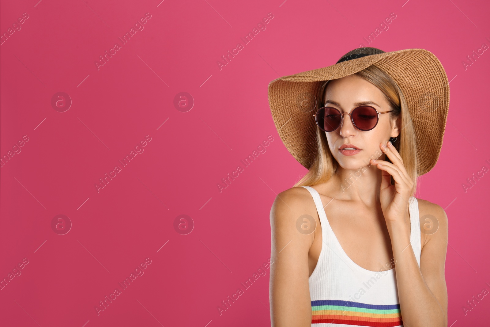 Photo of Beautiful woman in stylish sunglasses on pink background. Space for text