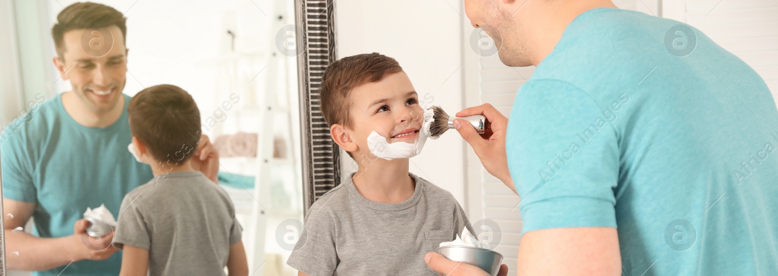 Image of Dad applying shaving foam onto son's face in bathroom. Banner design
