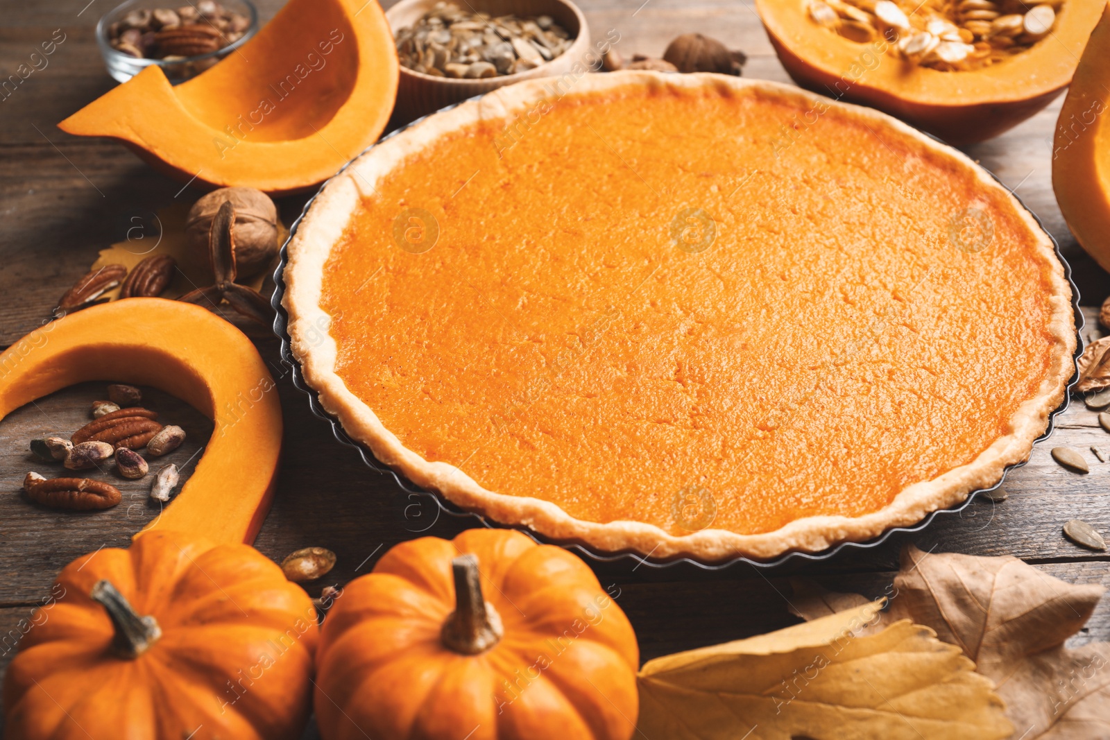 Photo of Delicious homemade pumpkin pie on wooden table