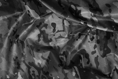 Image of Texture of crumpled camouflage fabric as background, top view. Black and white effect