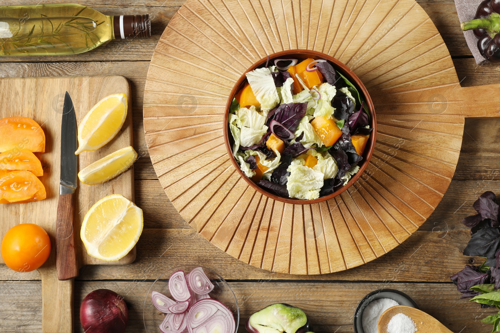 Photo of Delicious salad with Chinese cabbage, tomato and basil served on wooden table, flat lay