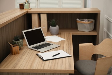 Photo of Receptionist's workplace with laptop in hotel. Interior design