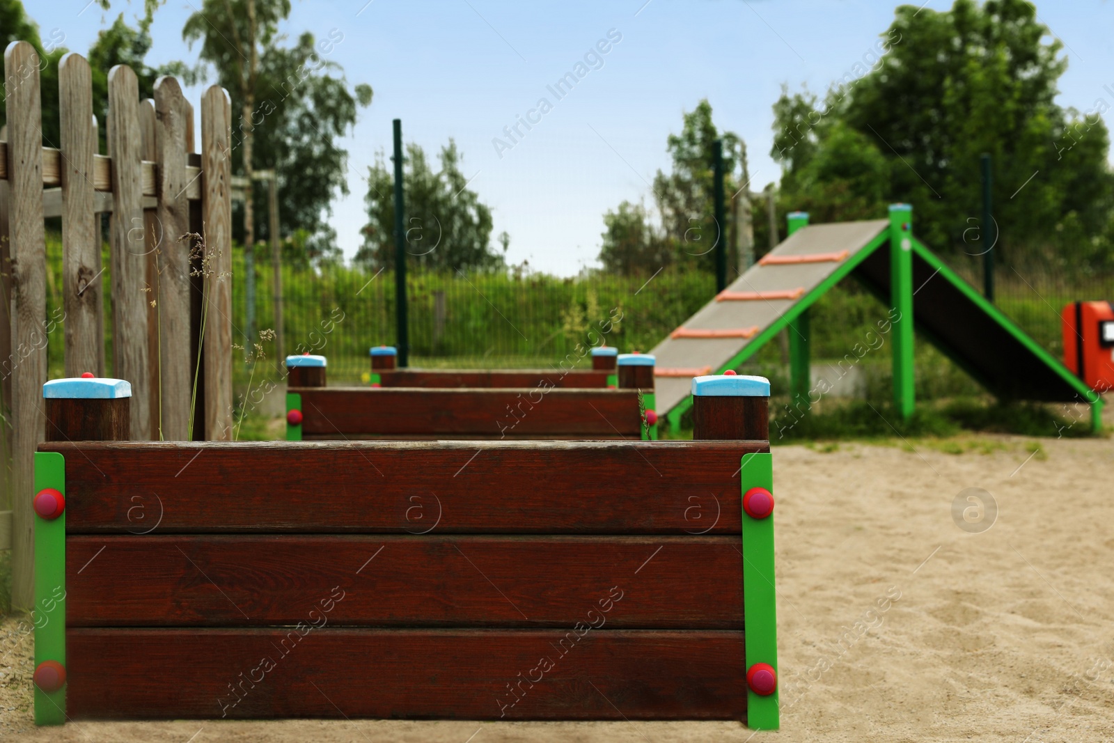 Photo of Wooden rover jump over and king of hill on animal training area outdoors