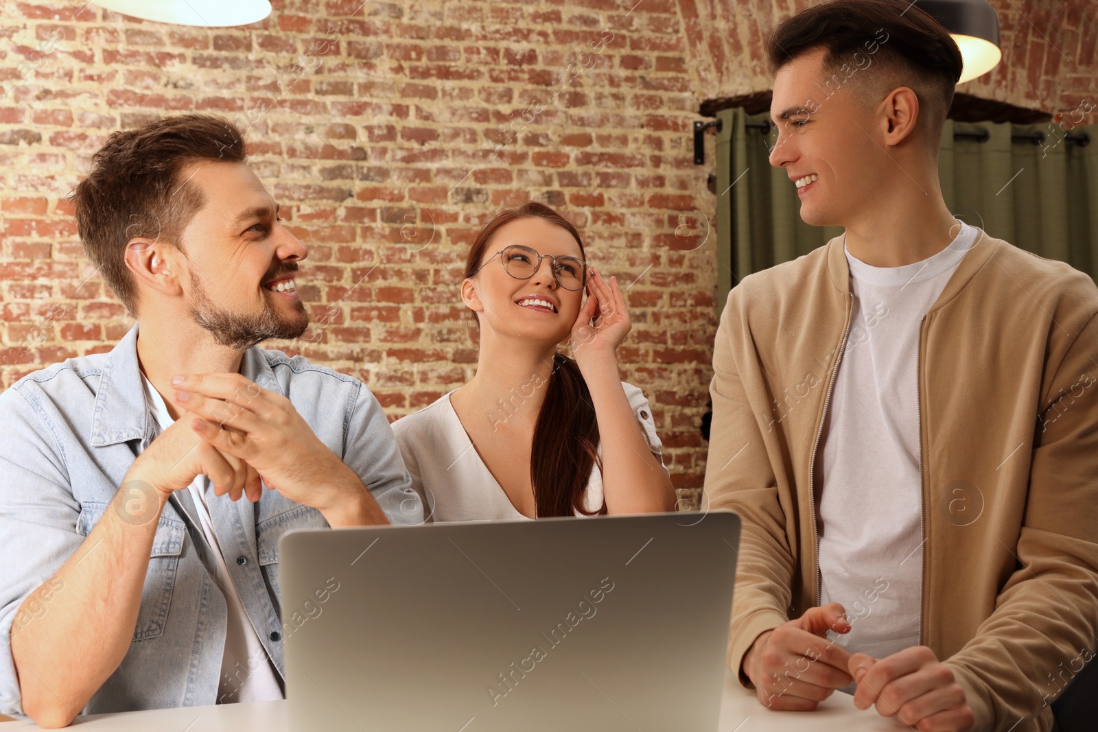 Photo of Team of employees working together in office