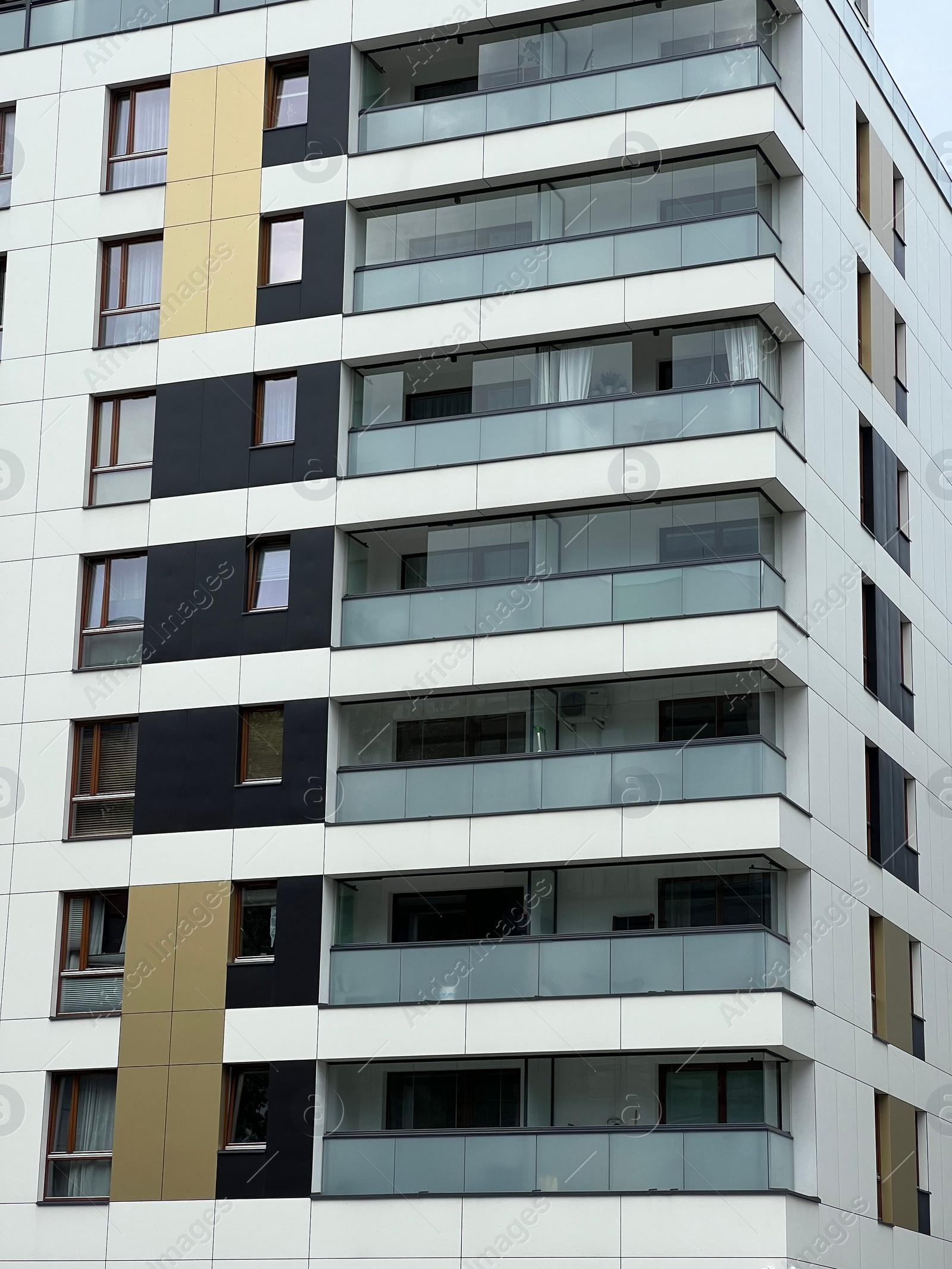 Photo of Exterior of beautiful residential building with balconies on city street