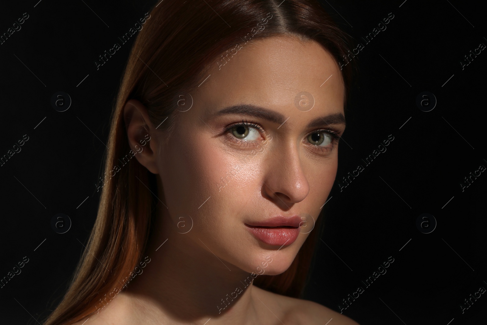 Photo of Evil eye. Young woman with scary eyes on black background