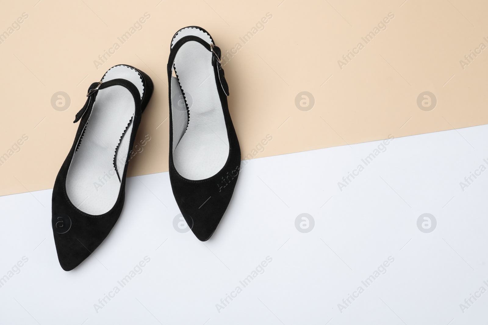 Photo of Stylish black female shoes on color background, flat lay. Space for text