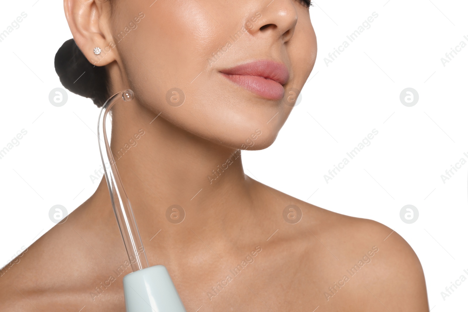 Photo of Woman using high frequency darsonval device on white background, closeup