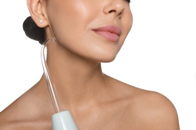 Photo of Woman using high frequency darsonval device on white background, closeup
