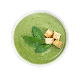 Photo of Delicious spinach cream soup with croutons in bowl isolated on white, top view