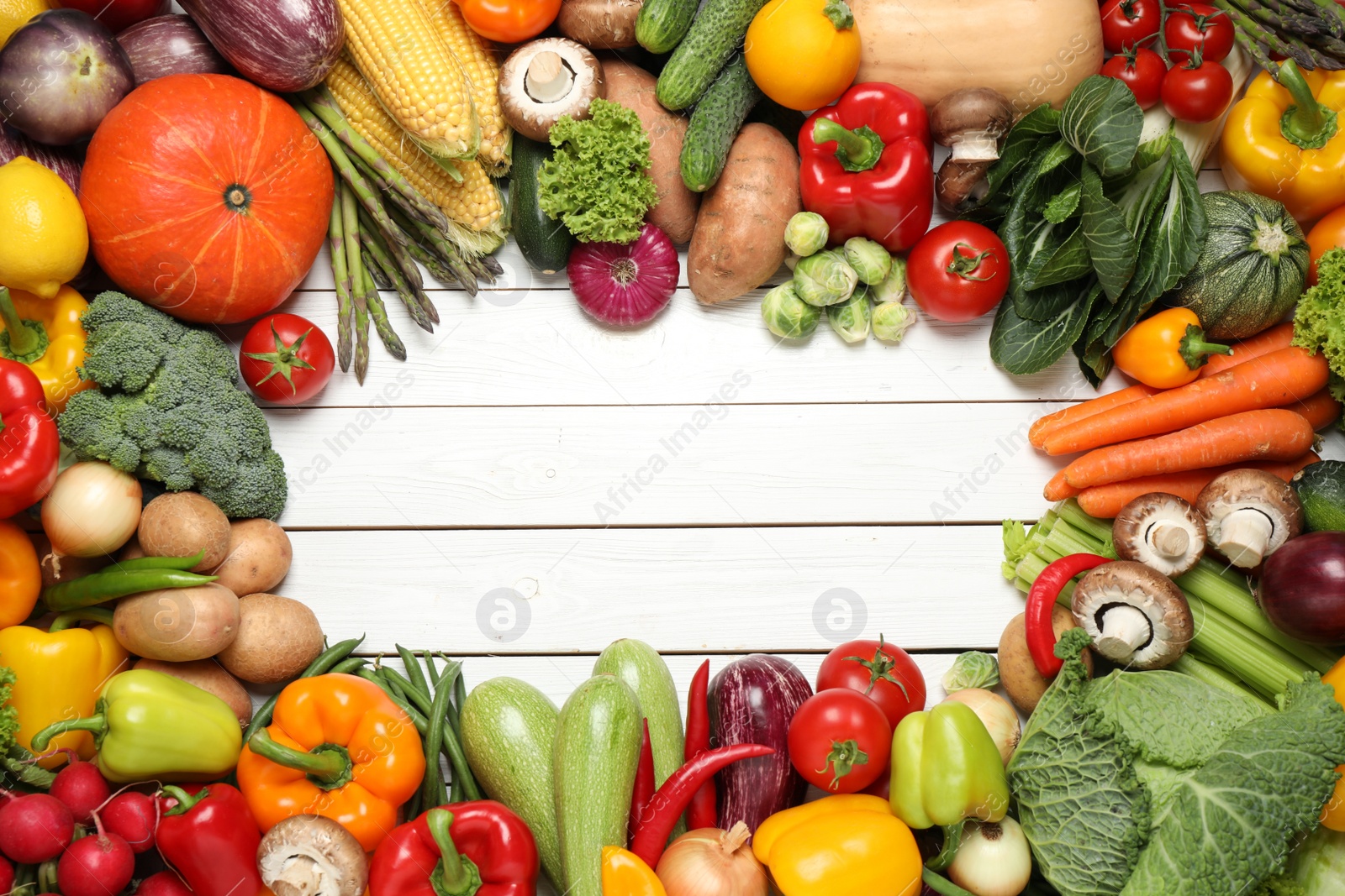 Photo of Frame of different fresh vegetables on white wooden table, flat lay. Space for text