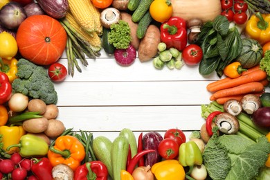 Photo of Framedifferent fresh vegetables on white wooden table, flat lay. Space for text