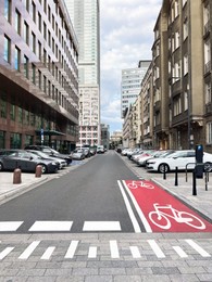 Photo of Different modern cars parked on city street