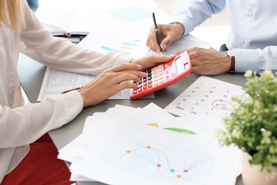 Tax accountants working with documents at table