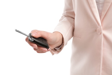 Woman holding car key isolated on white