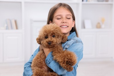 Little child with cute puppy at home. Lovely pet