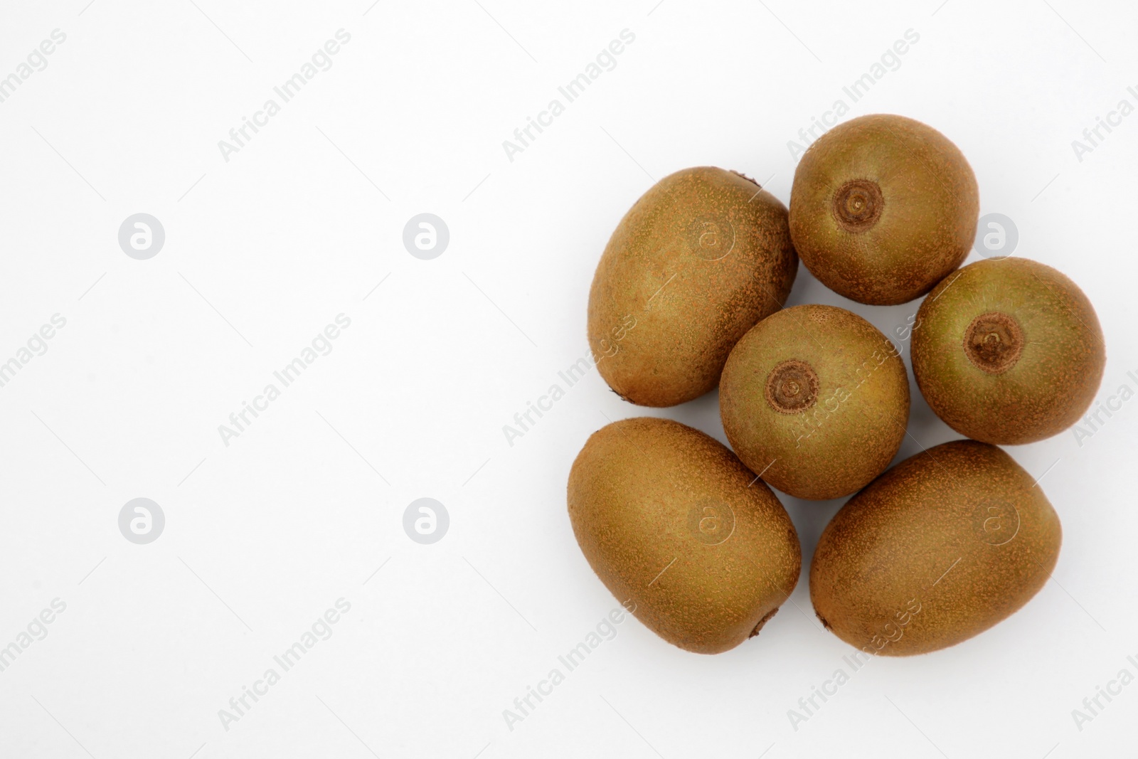 Photo of Whole fresh ripe kiwis on white background, top view