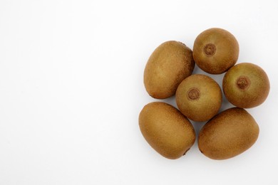 Photo of Whole fresh ripe kiwis on white background, top view