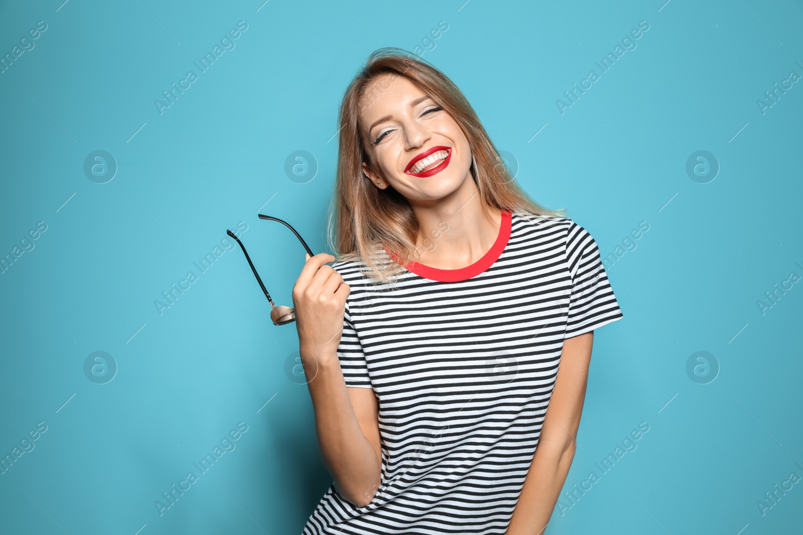 Photo of Beautiful young woman with healthy long blonde hair on color background