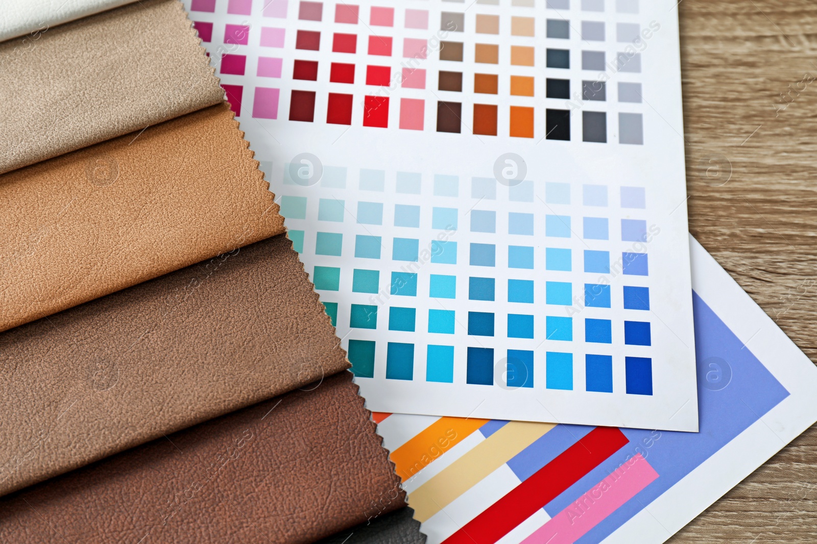 Photo of Upholstery fabric samples and color palette on table. Interior design