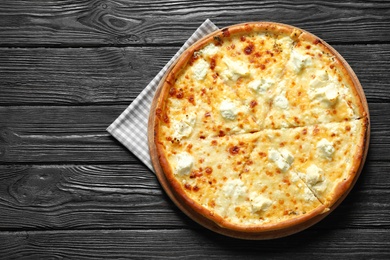 Tasty hot cheese pizza on wooden background, top view